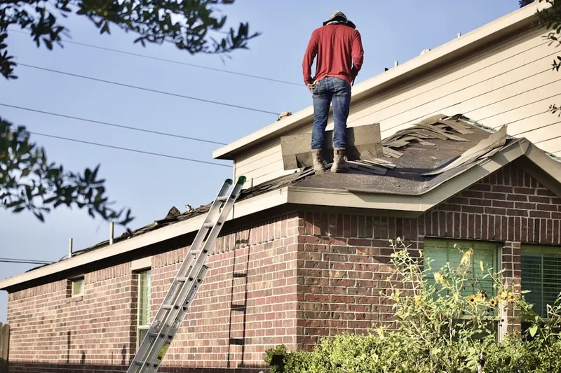 Professional roofer working on a residential roof in Radcliffeborough